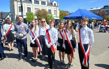 w słoneczny dzień uczniowie klas starszych reprezentują swoją szkołe