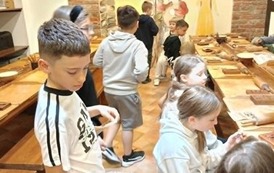 Uczeń częstuje piernikami koleg&oacute;w i koleżanki z klasy